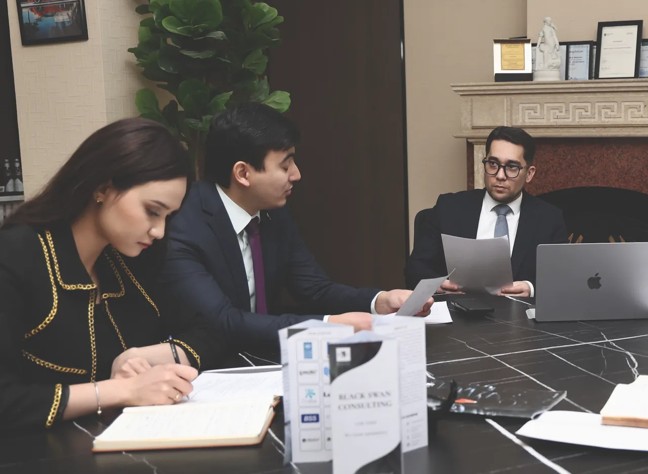 Black Swan Consulting lawyers working together at the boardroom table in Tashkent